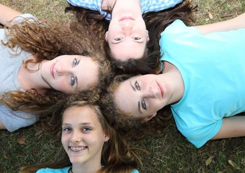 Four girls sleeping on grass