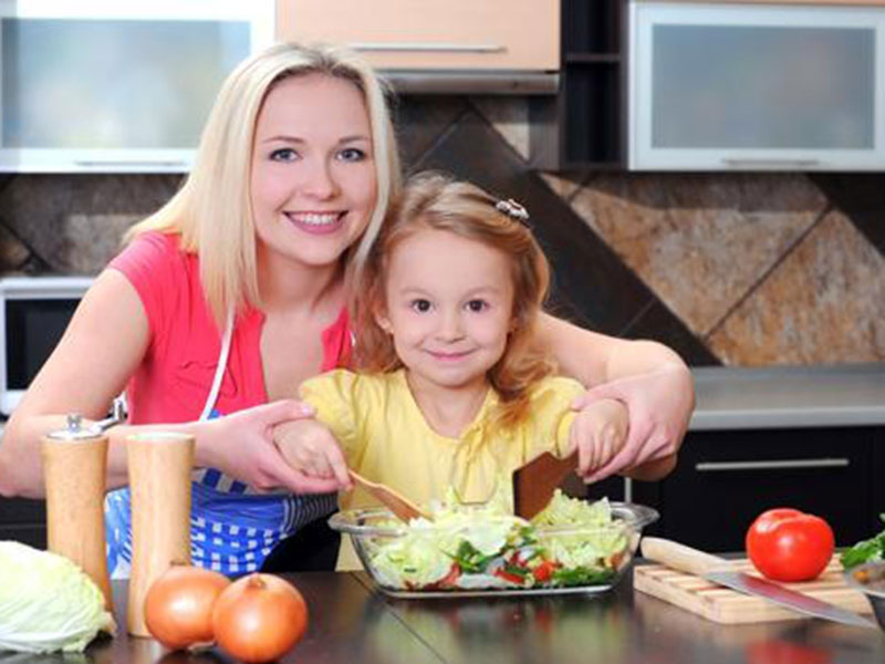 A mom with her child learning cooking 