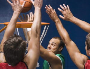 Basket ball player putting basket ball in the basket