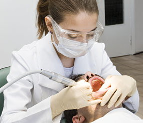 A dentist inspecting a patient