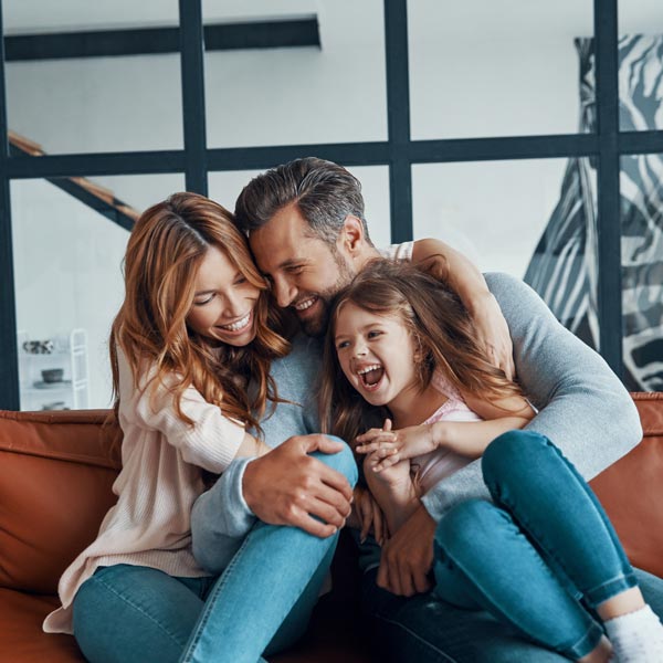laughing family of three